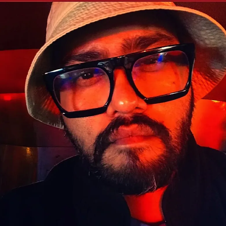 Tarun K. Verma, conservation science researcher, in a bucket hat and glasses
