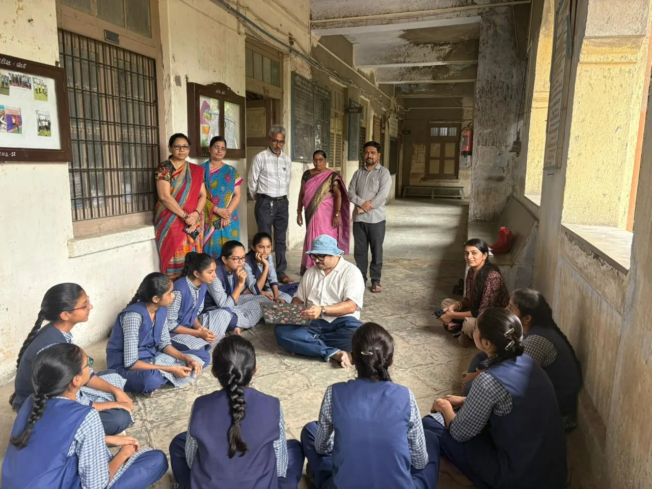 Students in school uniform sitting in a circle during fieldwork for the Tide Turners evaluation