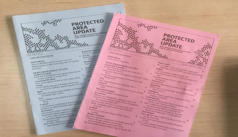 Two printed issues of the Protected Area Update newsletter by Kalpavriksh, listing news from India's protected areas state by state